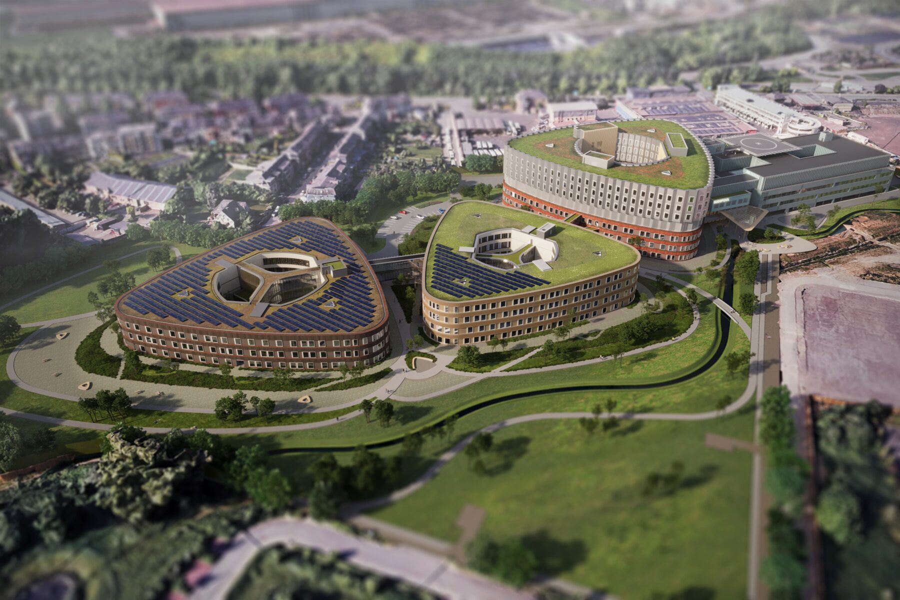 Vue aérienne de trois bâtiments de bureaux à toitures végétalisées équipées de panneaux solaires, entourés d’espaces verts, de sentiers et de parkings, présentés en perspective oblique pour illustrer un campus éco-responsable.